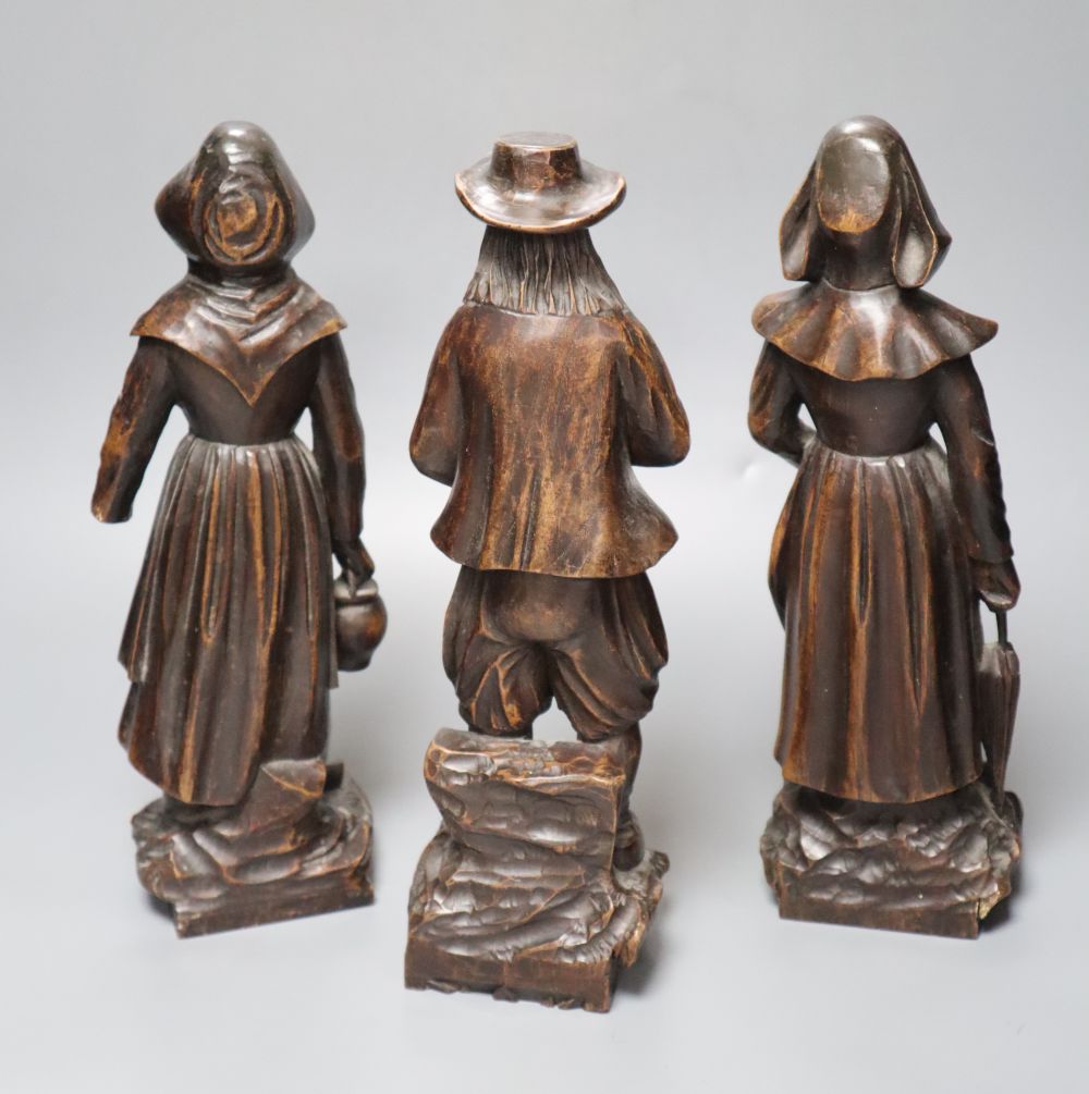 A set of three 19th century Dutch walnut figures of puritans, height 34cm